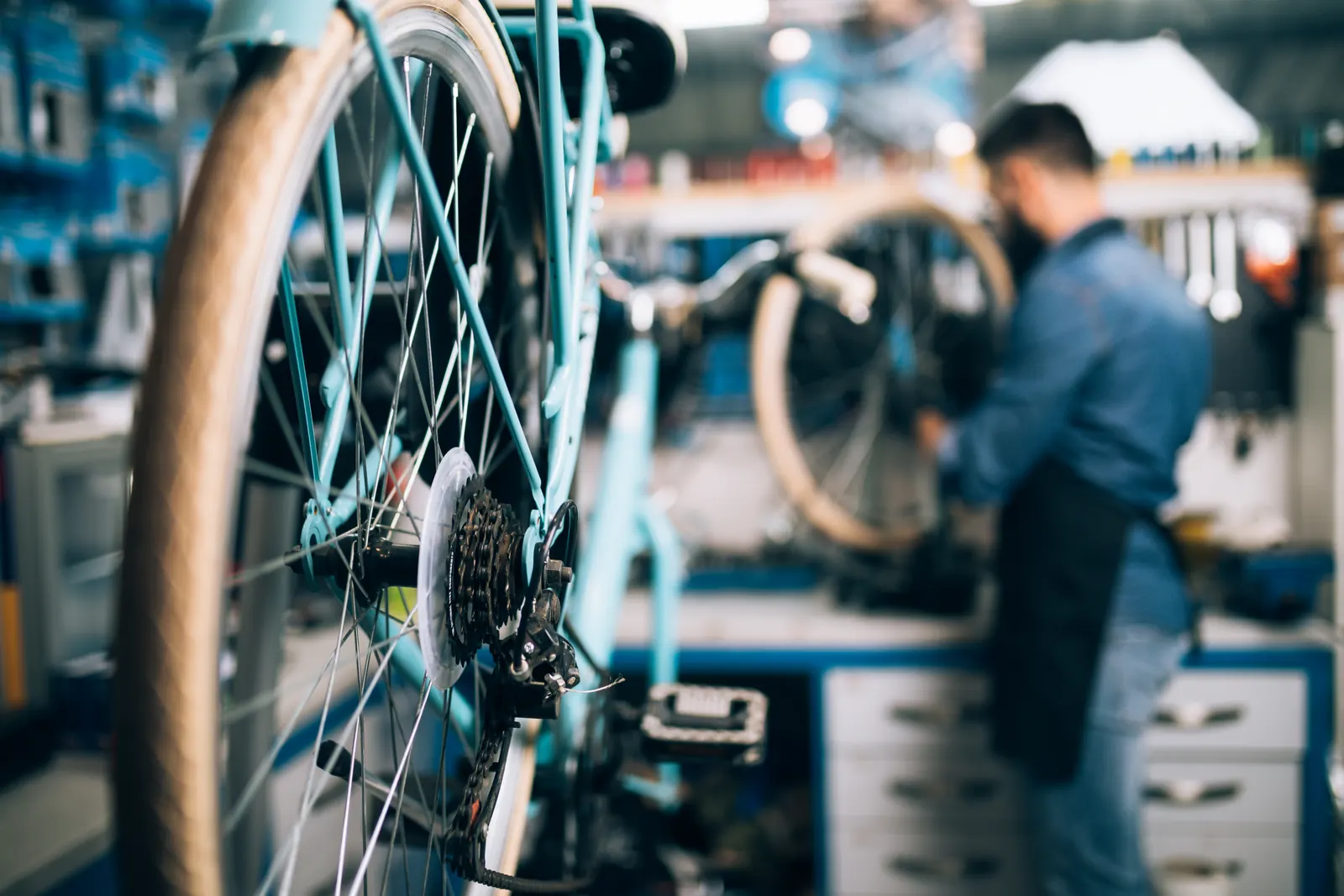 A bicycle and a mechanic in a repair workshop